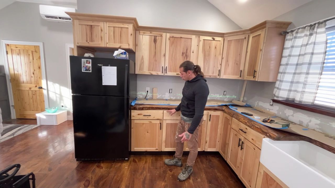 Kitchen remodel in progress with new cabinets and farmhouse sink